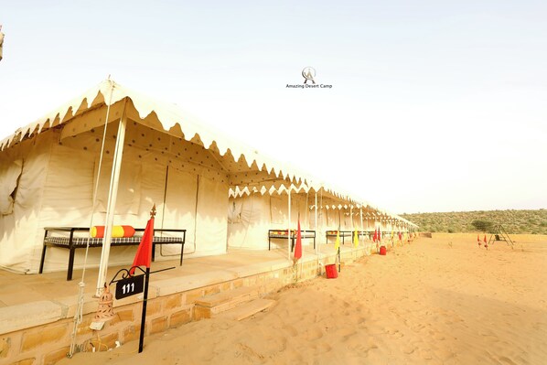 A desert camp with tents, numbered beds, and a sandy landscape. - Amazing Desert Camp (Jaisalmer)