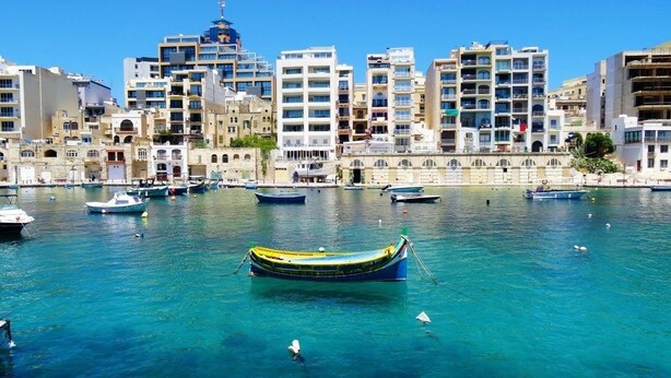 A marina with several boats docked, surrounded by multi-story buildings with balconies and windows. - Super 3 Bedroom Villa With Amazing Ocean Views (Swieqi)
