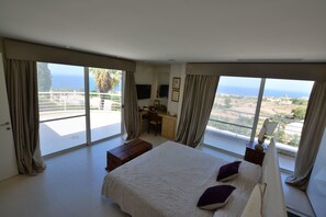 A bedroom with a large bed, a desk, and a view of the ocean. - Super 3 Bedroom Villa With Amazing Ocean Views (Swieqi)