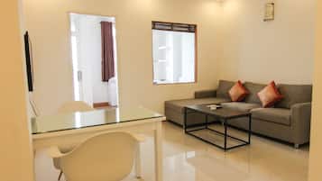 Deluxe Apartment, 1 Bedroom | Living area | Flat-screen TV