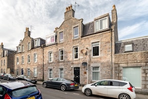 Traditional stone-built houses with pitched roofs and symmetrical windows.