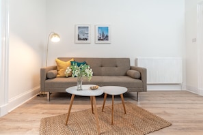 Relax in this stylish living room with a sofa, coffee table, and floor lamp.
