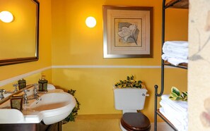 A bathroom with two sinks, a toilet, and a framed floral artwork on the wall. - Galway Manor House (Athenry)