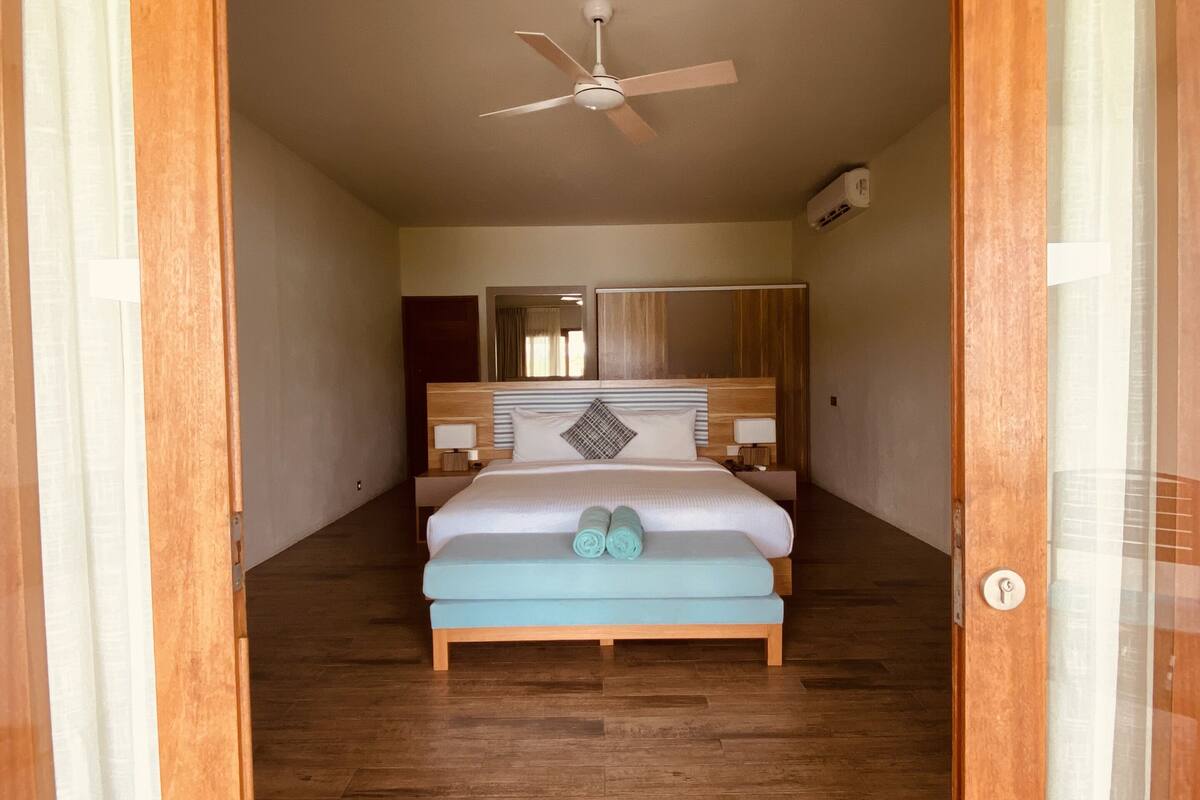 villa, 1 king bed, lagoon view | 1 bedroom, minibar, in-room safe, desk