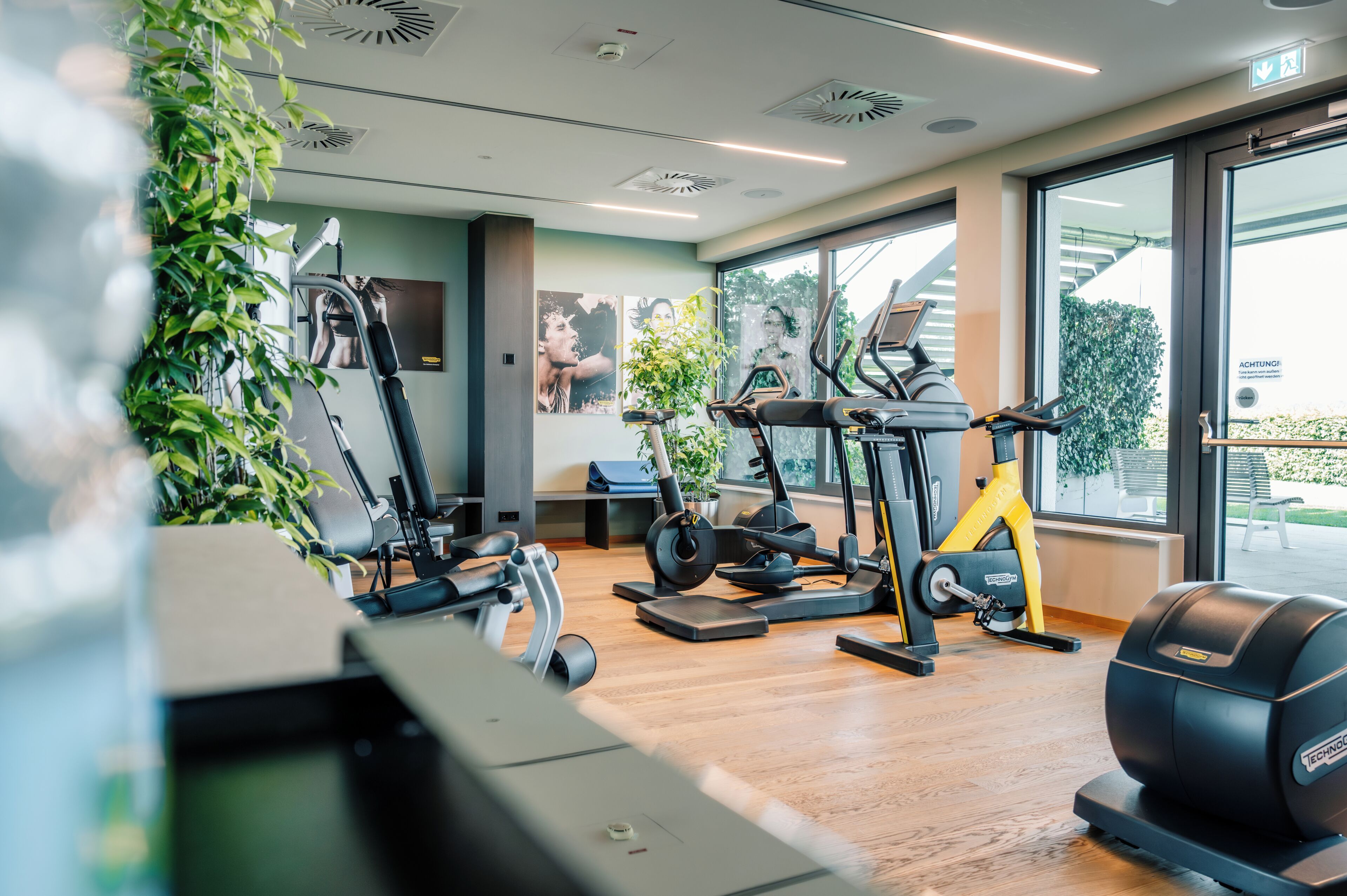 A gym with cardio machines, a treadmill, and a stationary bike.