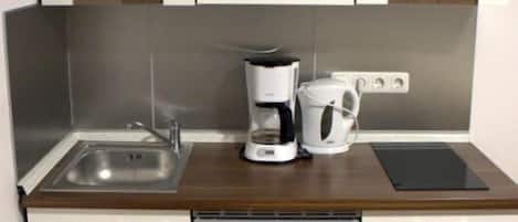 Fridge, stovetop, electric kettle, cookware/dishes/utensils