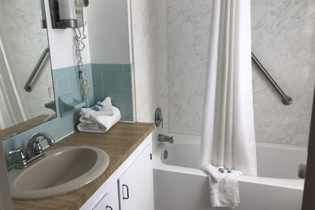 2 queen beds, poolside | bathroom | combined shower/bathtub, towels