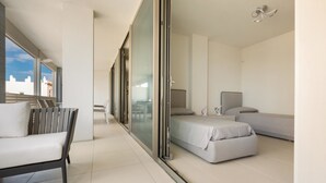 A modern hotel room with a balcony, a sofa, a bed, and a desk. - 1327 Appartamento Spinalonga by Barbarhouse (Gallipoli)