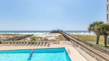 A swimming pool with a view of the beach and ocean.