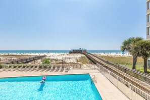 A swimming pool with a view of the beach and ocean. - Boardwalk Condos by Hosteeva (Gulf Shores)
