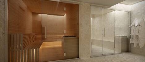 Un baño moderno con tocador de madera, cabina de ducha de vidrio y suelo de mármol.
