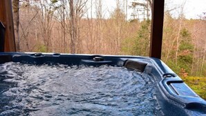 A hot tub with a view of a forested area. - Barefoot Lodge (Mineral Bluff)