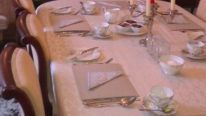 A dining room with a table set for four, featuring a chandelier, candles, and a fireplace. - Hartley House B&B (Carrick-on-Shannon)