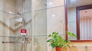 A modern bathroom with a glass-enclosed shower, a sink with a mirror, and a potted plant. - Hangzhou Wangsu Hotel Letong (Hangzhou)