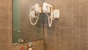 A bathroom with a large mirror, a sink, and two hair dryers mounted on the wall. - 118 Inn Hangzhou Xiaoshan Nanxiu Road (Hangzhou)