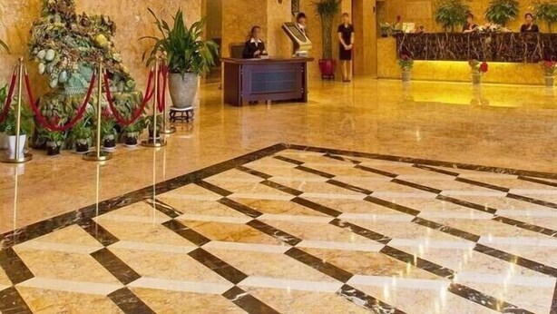 A spacious lobby with a grand chandelier, a reception desk, and a check-in counter. - Tieliu Business Hotel (Hangzhou)