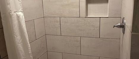Jetted bath, rainfall showerhead, towels