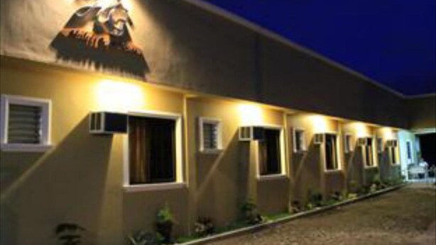 A building with multiple rooms, each with a window and an air conditioning unit. - Heilee's Guest House (General Santos)