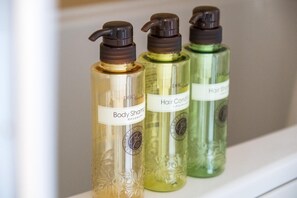 Three bottles of body and hair care products on a shelf. - Meet Inn Narita (Narita)