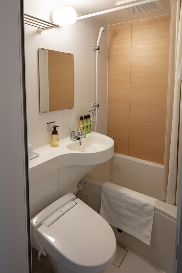 A modern bathroom with a white sink, mirror, and toilet. There are toiletries on the sink and a towel hanging on the wall. - Meet Inn Narita (Narita)