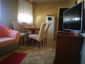 Family Apartment, Multiple Beds | Living area | Flat-screen TV