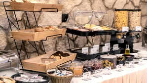 A buffet setup with various food items and beverages. - Athens Manor Houses Suites Apartments (Athens)