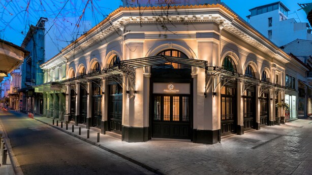 A historic building with a classic facade, large arched windows, and a prominent entrance. - Athens Manor Houses Suites Apartments (Athens)