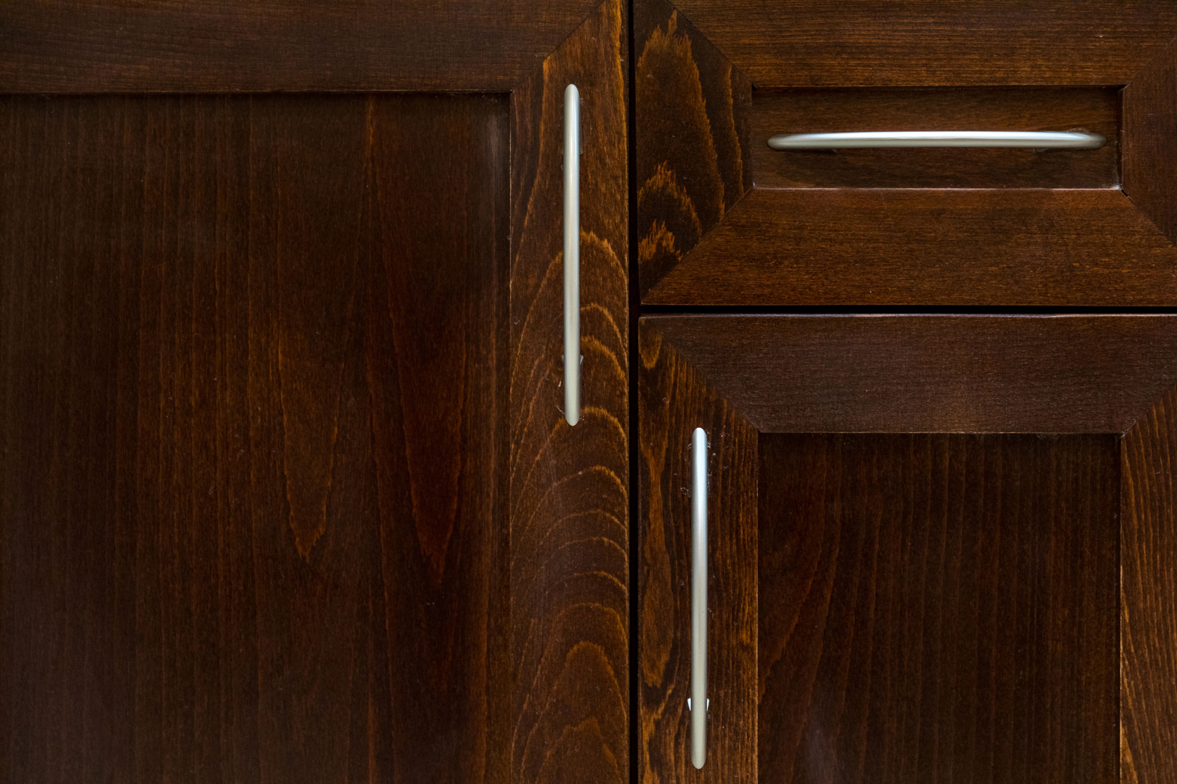 A wooden cabinet with a drawer and a handle.