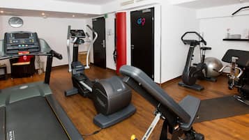 A gym with treadmills, elliptical machines, and weight equipment.