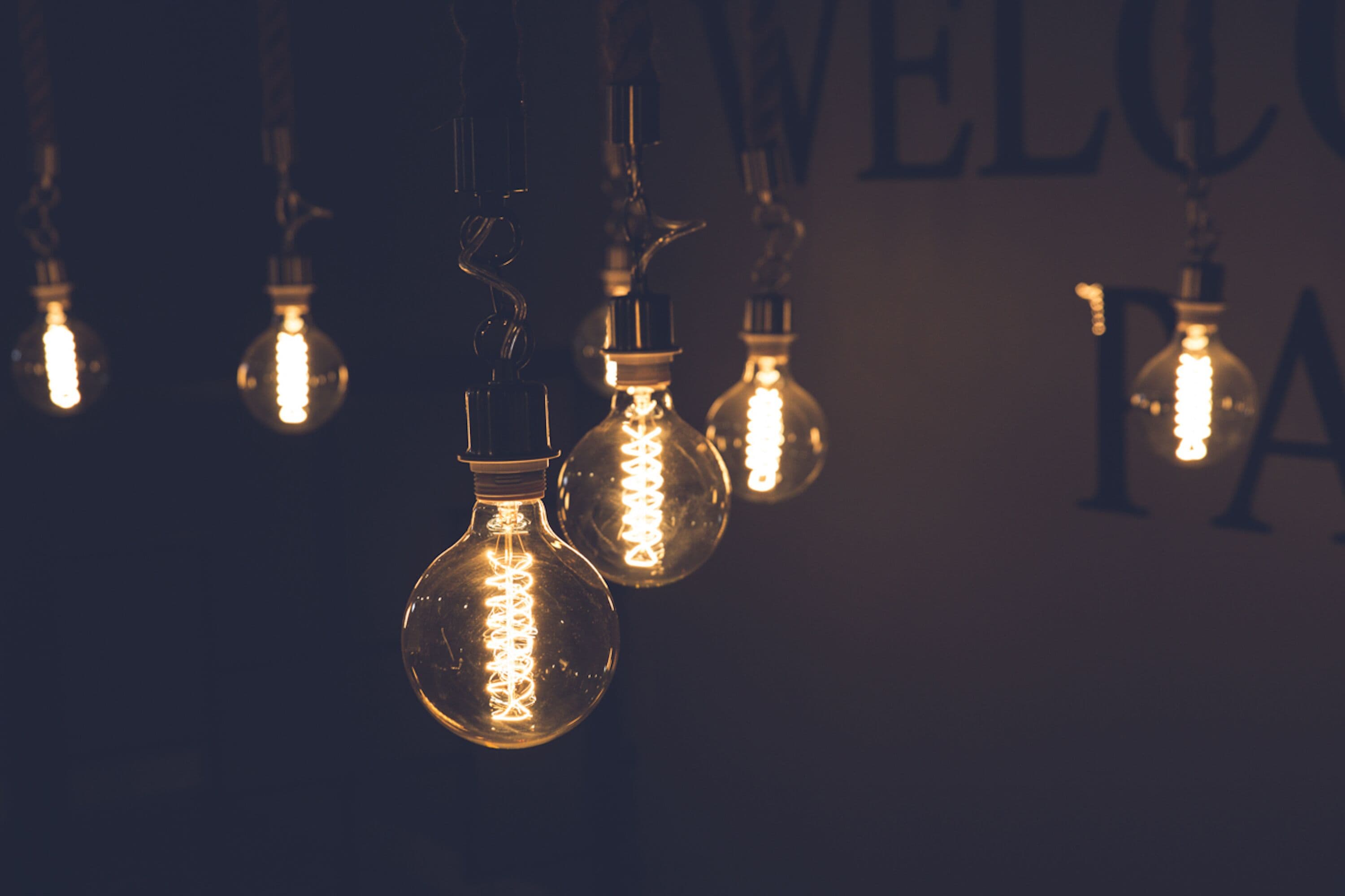 Several illuminated light bulbs hanging from the ceiling.