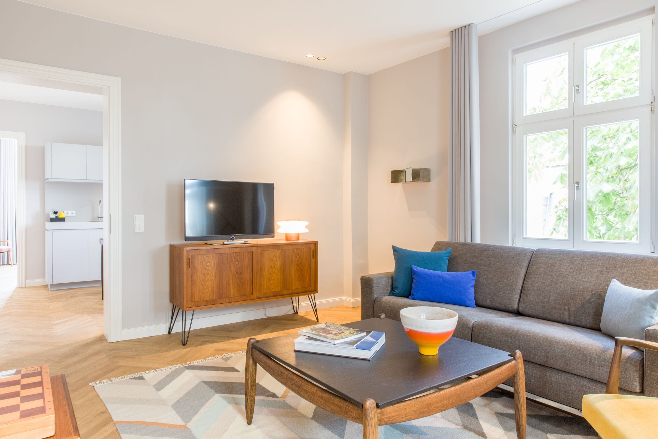 A modern living room with a sofa, coffee table, and television.