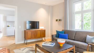A modern living room with a sofa, coffee table, and television.