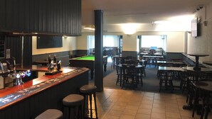 A bar area with stools, a pool table, and a billiards table. - The Pheasant Inn (Dunstable)