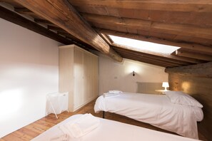 A room with two beds, a wardrobe, and a skylight. - Vigna Nuova (Florence)