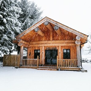 A wooden cabin with a porch and a door labeled "LOFT & BAR." - Braisty Woods - Hopes & Beams (Harrogate)