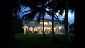 A large, multi-story building with a symmetrical facade, arched windows, and a central entrance. - Baoba Breeze Bed & Breakfast (Cabrera)