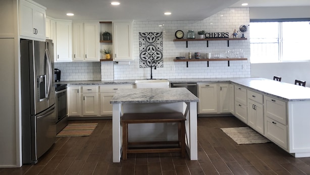 A modern kitchen with white cabinets, a marble countertop, and a built-in dishwasher. - Casa Tranquila Puerto Nuevo with Ocean and Mountain View that Sleeps 20 (Puerto Nuevo)