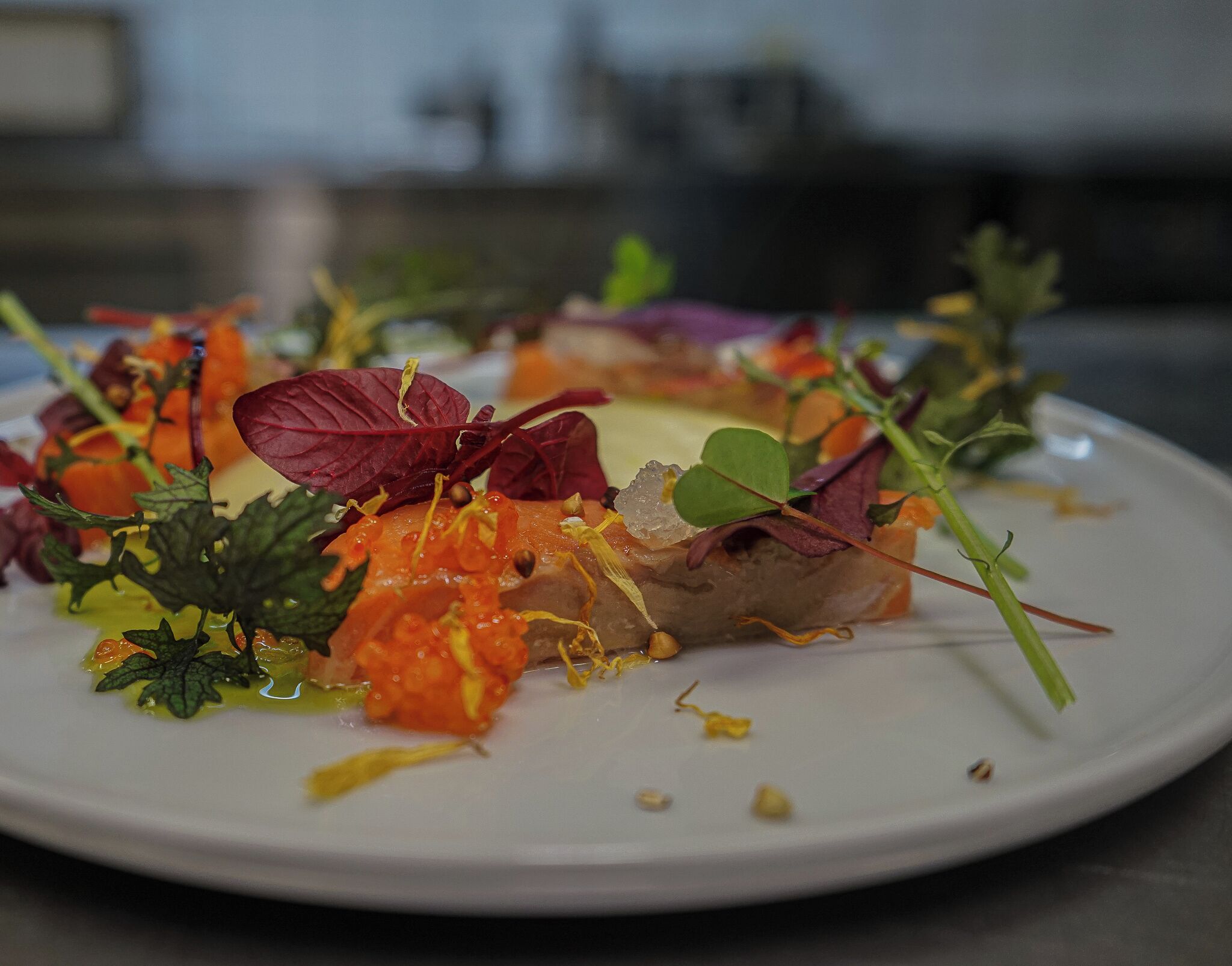 A plate of food with various vegetables and garnishes.
