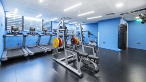 A gym with treadmills, weight machines, and a punching bag. - Yugo Explore - Ardcairn House (Dublin)