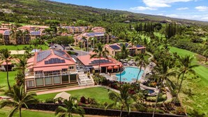 A resort with multiple buildings, a swimming pool, and lush greenery. - Kona Coast Resort at Keauhou Gardens 8204 (Kailua-Kona)