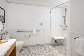 A modern bathroom with a toilet, bidet, and shower.