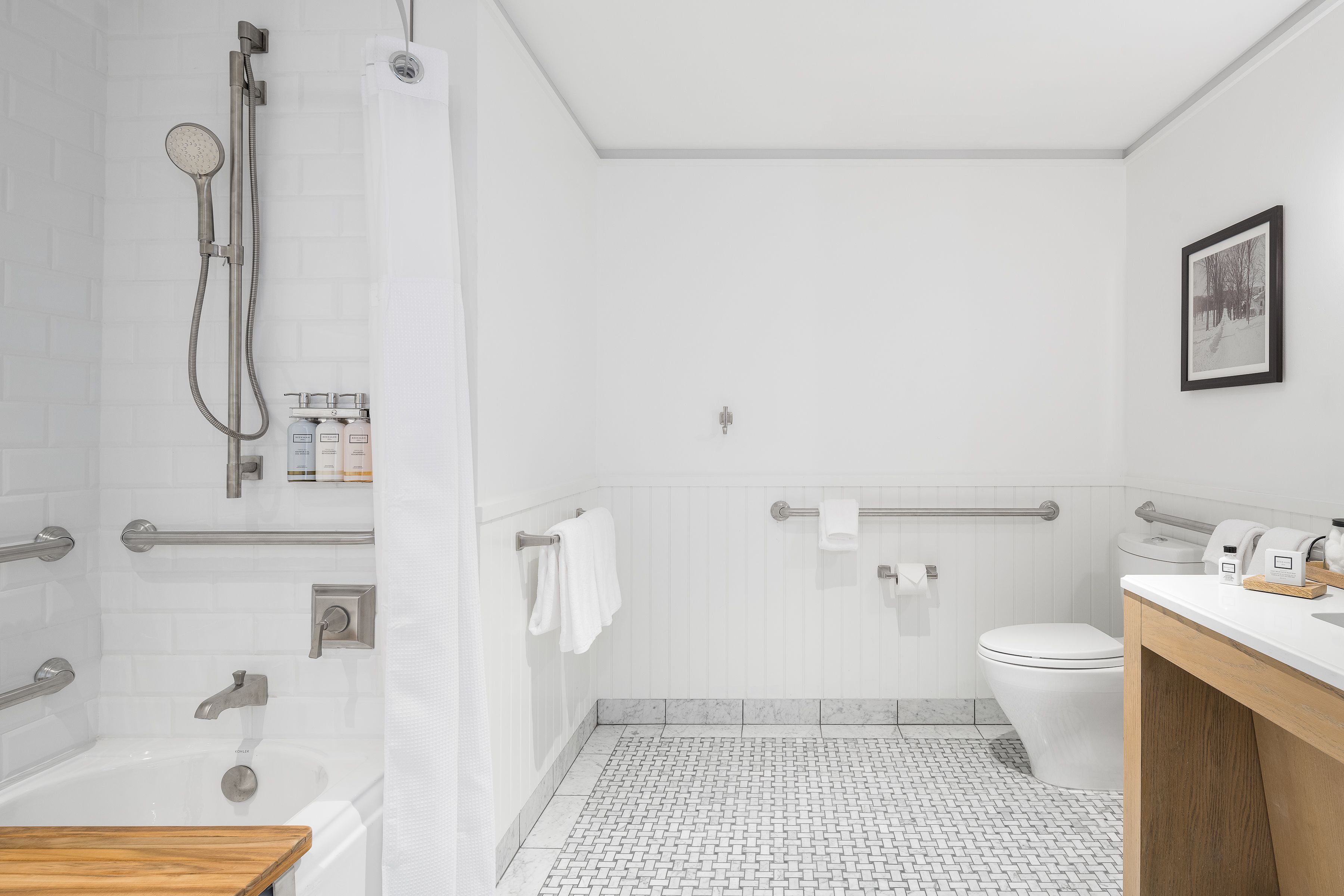 A modern bathroom with a bathtub, shower, toilet, and vanity.