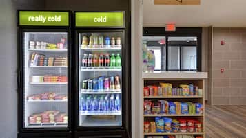 Two refrigerated beverage dispensers labeled "really cold" and "cold," with shelves stocked with various drinks and snacks.