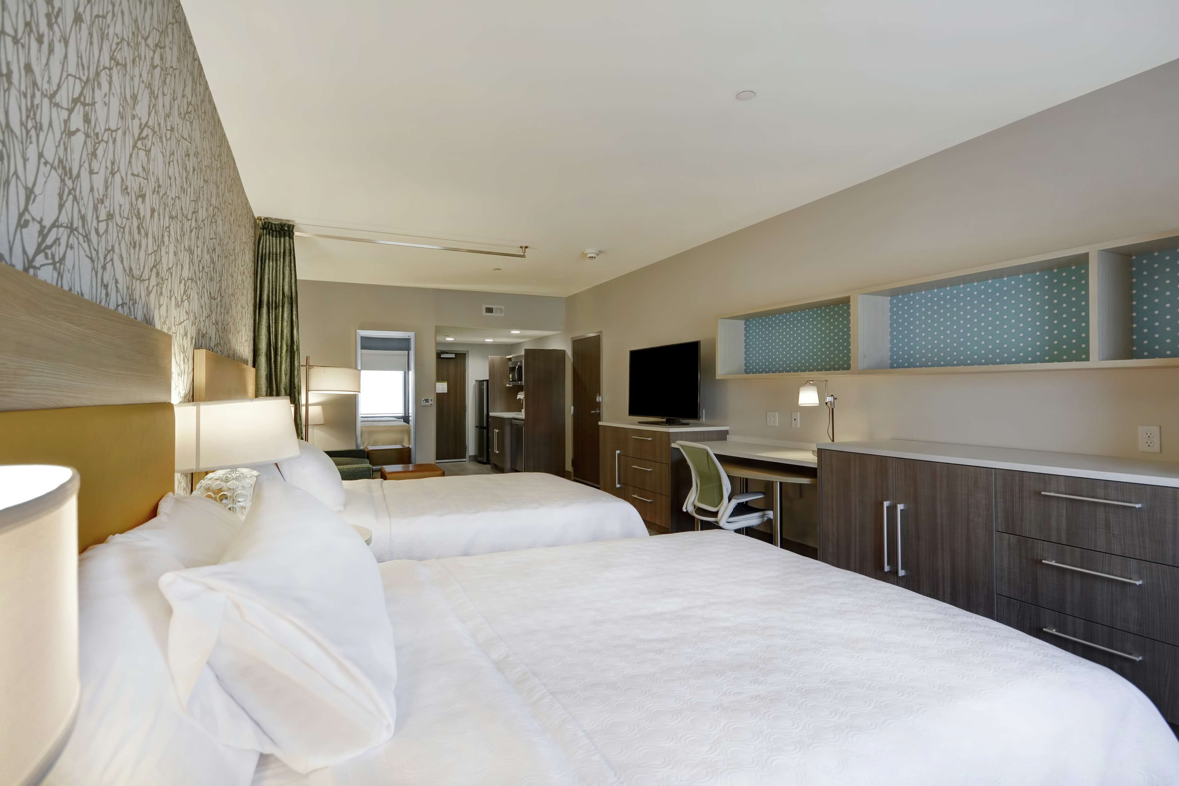 pillow-top beds, desk, laptop workspace, blackout curtains