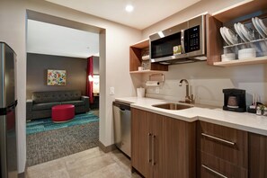 A modern kitchen with stainless steel appliances, a dishwasher, and a coffee maker. - Home2 Suites by Hilton Atlanta Marietta (Marietta)