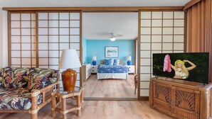 A traditional Japanese-style room with tatami flooring, a low wooden bed, a television, and a sliding shoji screen. - Keauhou Kona Surf & Racquet Club 3202 (Kailua-Kona)