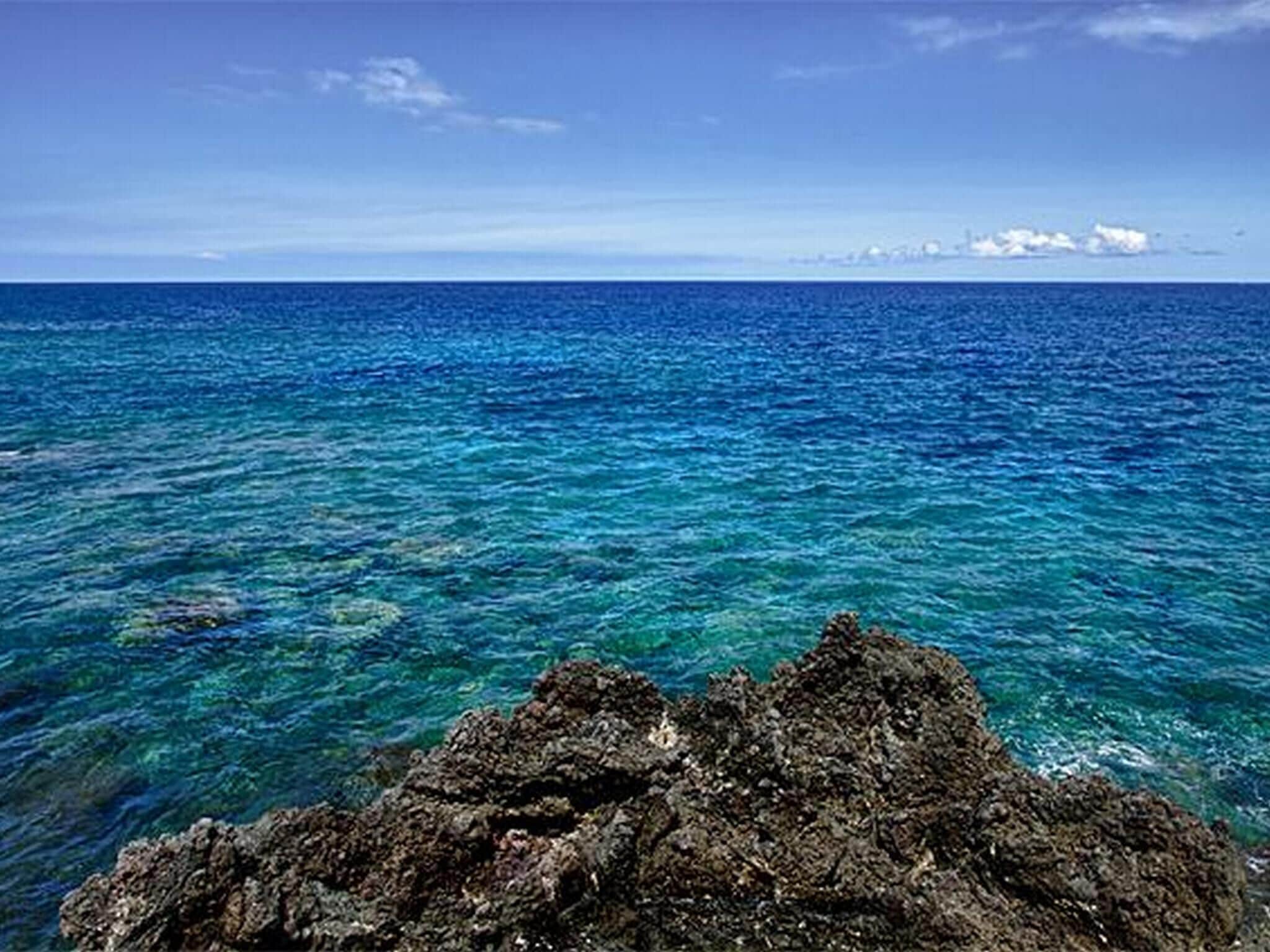 A rocky coastline with clear blue waters.