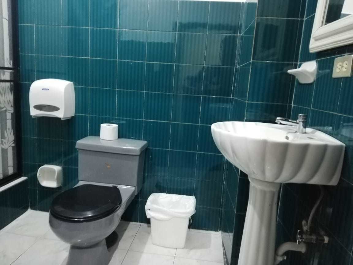 A bathroom with a toilet, bidet, and sink.