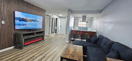 65-inch LED TV with satellite channels. Olympic Suites Inn