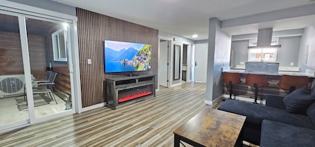 65-inch LED TV with satellite channels. Olympic Suites Inn